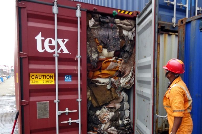 Srilankan official examines trash container
